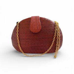 Brick red woven wicker clutch handbag with a gold-toned chain strap